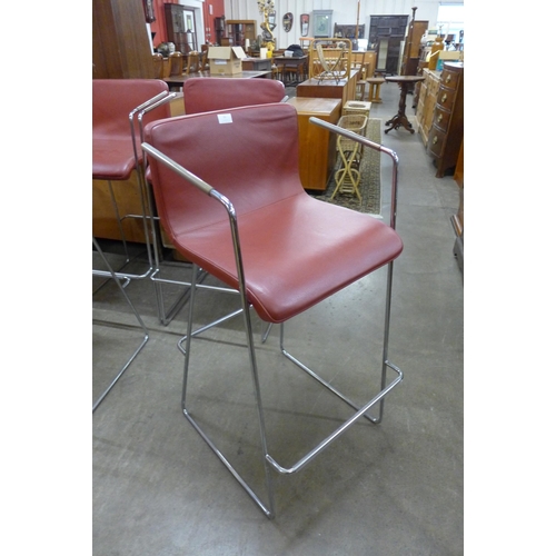 56 - A set of four chrome and red vinyl bar stools