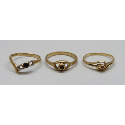 1003 - Two 9ct gold rings and a 14ct gold ring, all lacking stones, 2.9g 9ct, 1.3g 14ct