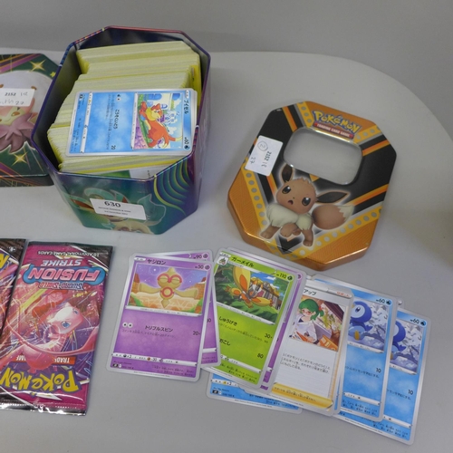 630 - A collection of Pokemon cards in two tins