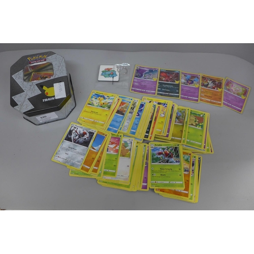 644 - Pokemon cards; a Pokemon collectors tin containing 150 basic Pokemon cards, five holographic cards a... 