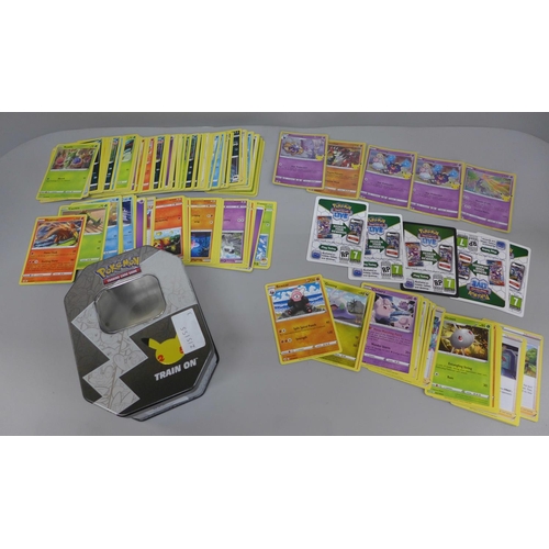 646 - Pokemon cards; a Pokemon collectors tin containing 150 basic Pokemon cards and five holographic card... 