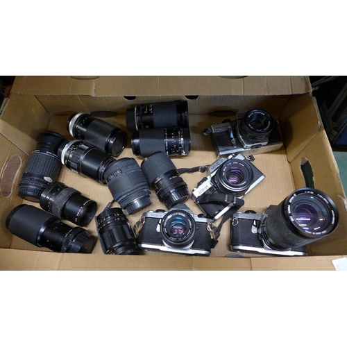 652 - Four vintage SLR cameras and ten lenses