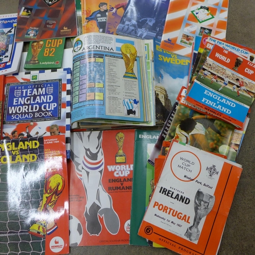 702 - Football memorabilia; a box of World Cup related books and programmes, 1950's onwards includes North... 