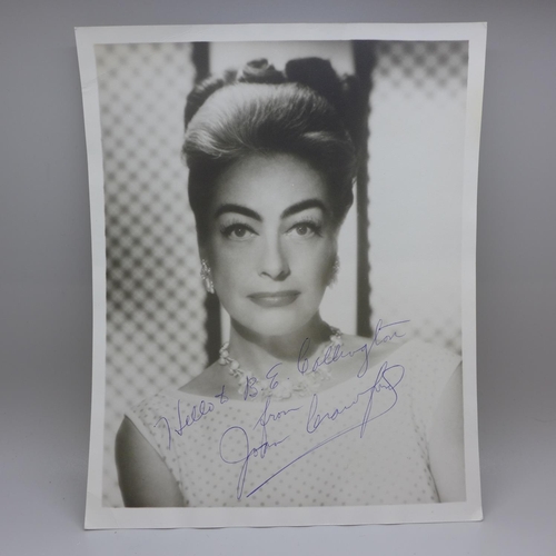 773 - Joan Crawford: a black and white publicity photo, signed in blue biro, with original postage envelop... 