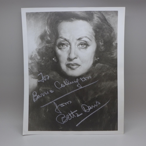 775 - Bette Davis: a black and white publicity portrait, signed in white pen, with original postage envelo... 