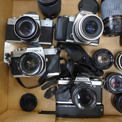 802 - Four vintage SLR cameras and ten lenses