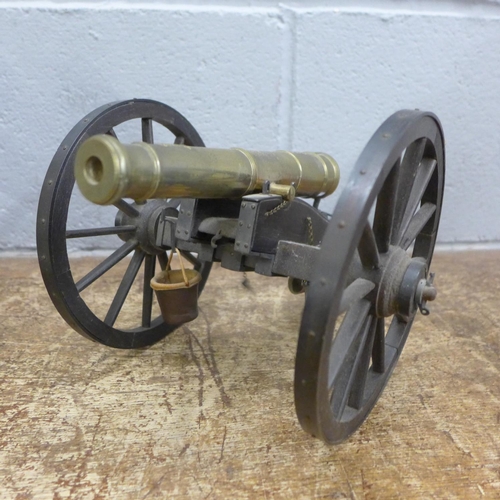 827 - A brass and wood model cannon