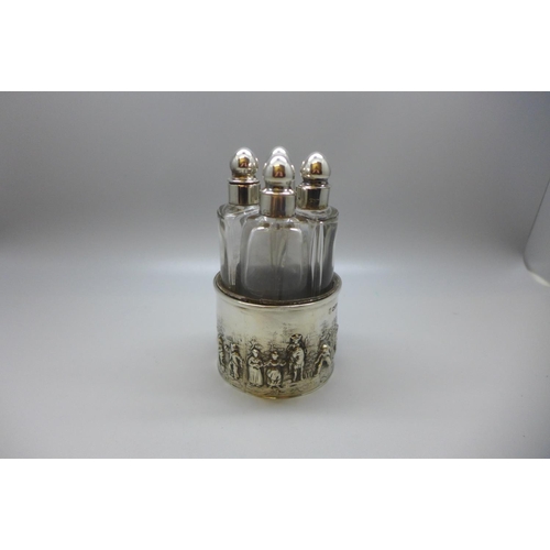 847 - Four silver topped perfume bottles, silver embossed themed holder, 49g, Chester 1903