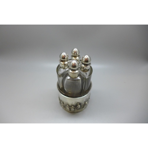 847 - Four silver topped perfume bottles, silver embossed themed holder, 49g, Chester 1903