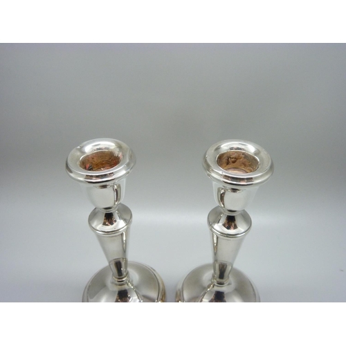 862 - A pair of silver candlesticks, weighted bases, 259g, one a/f