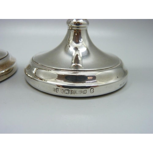 862 - A pair of silver candlesticks, weighted bases, 259g, one a/f