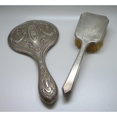 871 - A silver hand mirror and silver brush