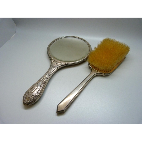 871 - A silver hand mirror and silver brush