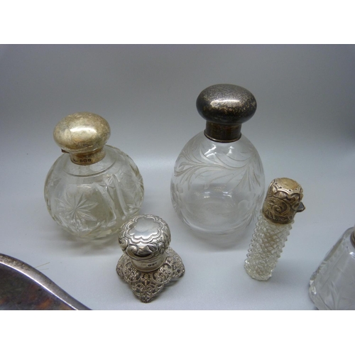 880 - Two silver topped globular scent bottles, silver spoon, silver brush, etc.