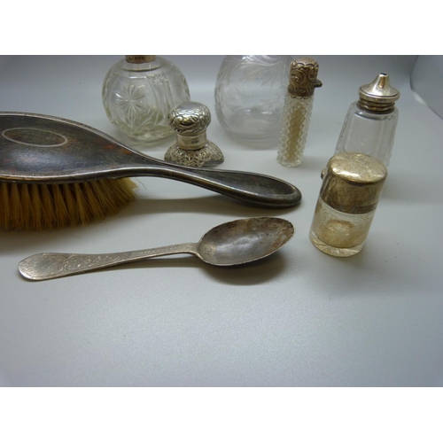 880 - Two silver topped globular scent bottles, silver spoon, silver brush, etc.