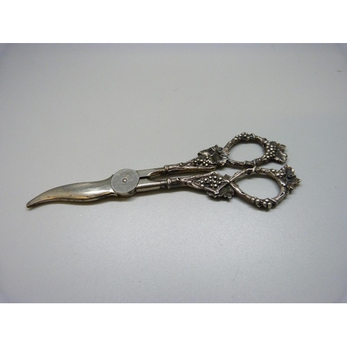 898 - A pair of sterling silver cast handled grape scissors, marked inside the bottom of handle, 85g