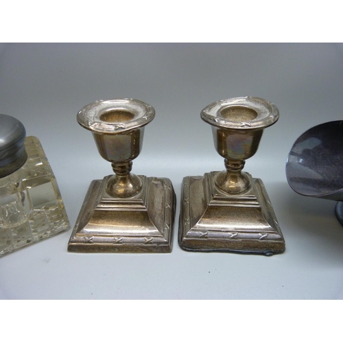 920 - A pair of silver candlesticks, a/f, a brush with applied silver decoration, a metal topped inkwell a... 