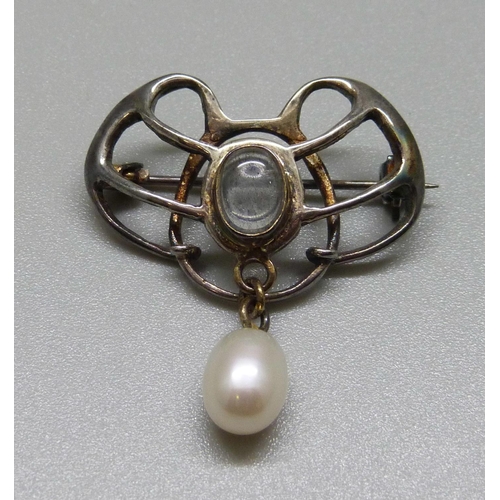 986 - An Art Nouveau white metal brooch, set with moonstone and a pearl drop