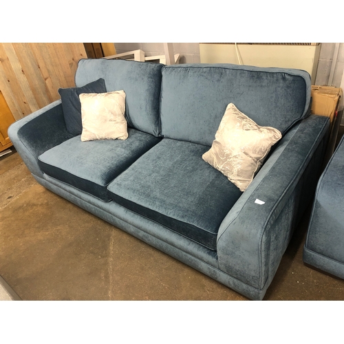 1302 - A steel blue upholstered three seater sofa