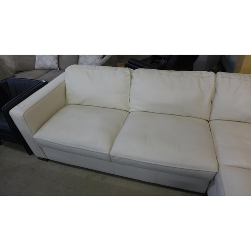 1560 - A Natuzzi two piece sectional cream leather sofa, original RRP £1916.66 + VAT, damaged leather on ba... 