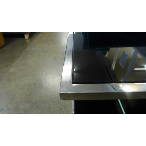 1433 - A chrome and black glass top coffee table