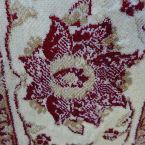 1587 - A red and cream ground Cashmere with all-over floral pattern (230cm x 160cm)