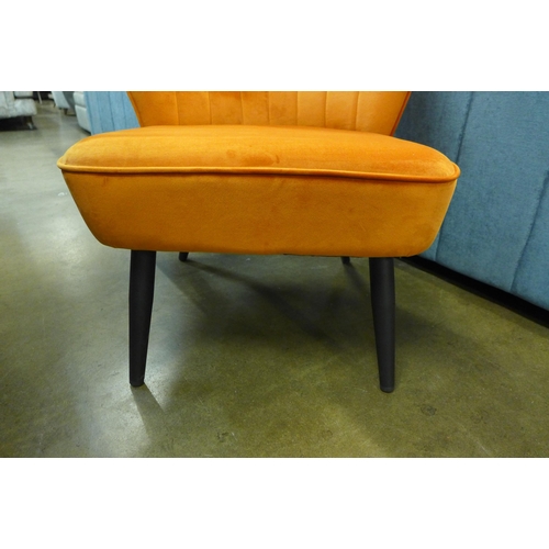 1301 - An orange velvet alpha chair