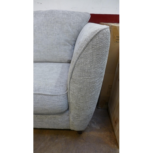 1423 - An oatmeal upholstered three seater sofa - RRP £1099