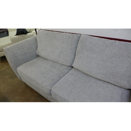 1423 - An oatmeal upholstered three seater sofa - RRP £1099