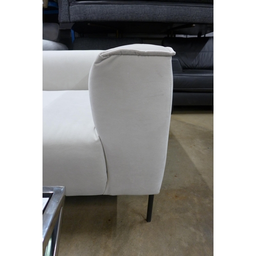 1432 - An off white corner sofa on steel legs