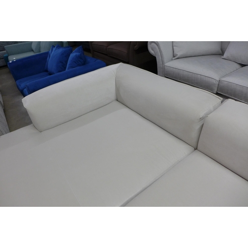 1432 - An off white corner sofa on steel legs