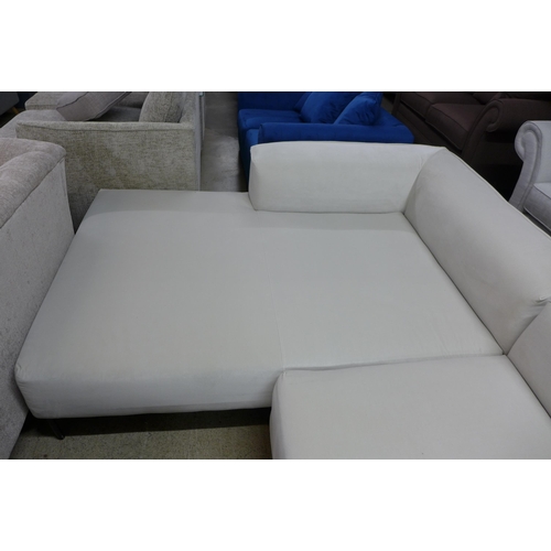 1432 - An off white corner sofa on steel legs