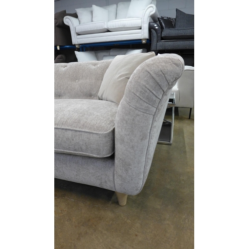 1434 - A stone upholstered buttoned four seater sofa