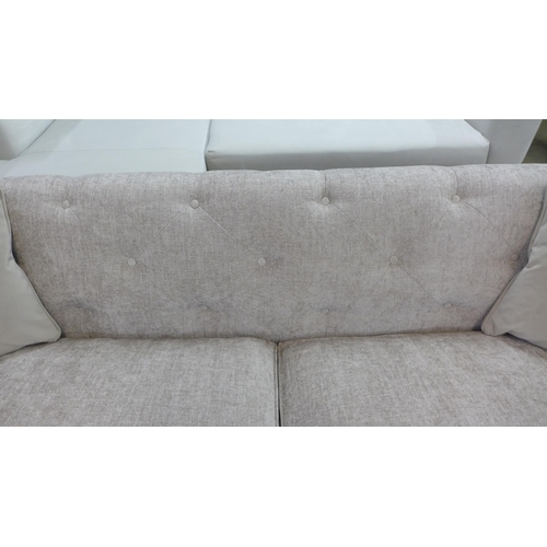 1434 - A stone upholstered buttoned four seater sofa