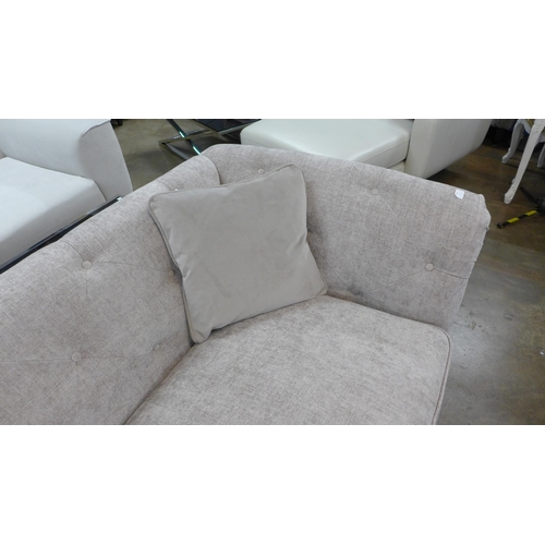 1434 - A stone upholstered buttoned four seater sofa