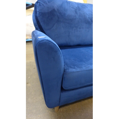 1463 - A blue velvet three seater sofa with choice of back cushions