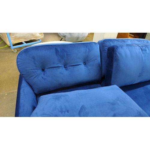 1463 - A blue velvet three seater sofa with choice of back cushions