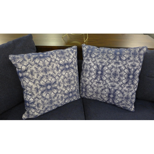 1494 - A blue velvet three seater sofa