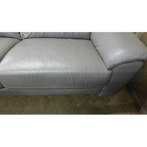 1526 - A grey leather three seater sofa - damaged leg