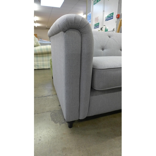 1527 - A grey upholstered buttoned three seater sofa