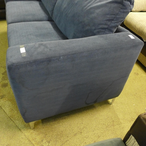 1563 - A blue velvet upholstered three seater sofa - stained on side