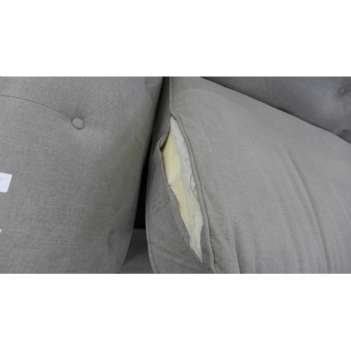 1578 - A grey buttoned four seater sofa - torn cushion