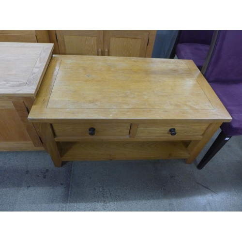 1643 - An oak TV stand, coffee table, bookcase and two drawer bedside chest