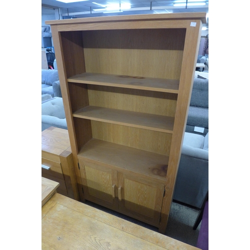 1643 - An oak TV stand, coffee table, bookcase and two drawer bedside chest