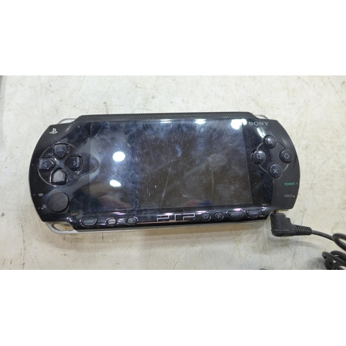 2228 - hand held console job lot 2 PSP consoles with games and charger cable with Nintendo wii U