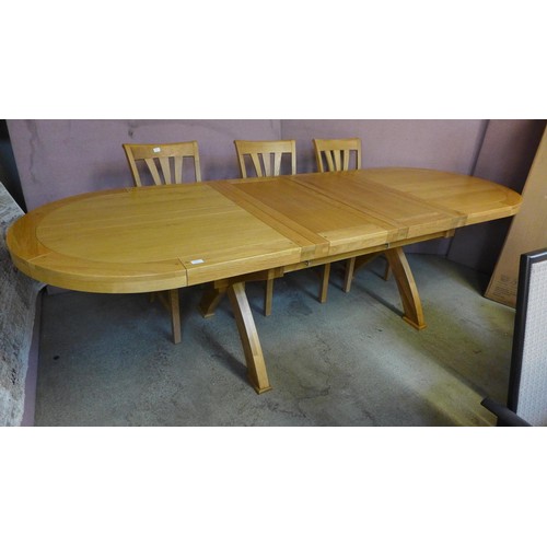 1591 - A solid oak double extending dining table with a 'X' base