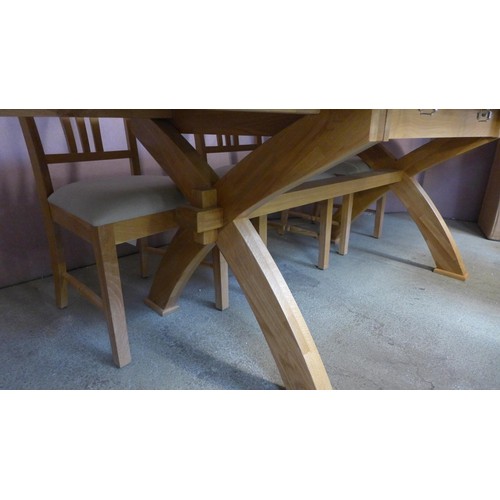 1591 - A solid oak double extending dining table with a 'X' base