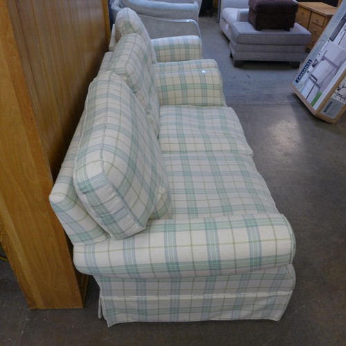 1638 - An off white and green plaid three seater sofa and armchair