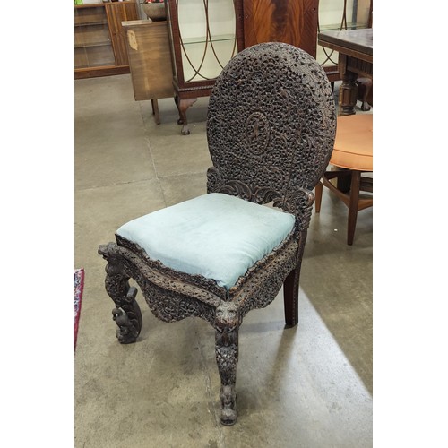 184 - A pair of Anglo Indian carved padouk wood chairs