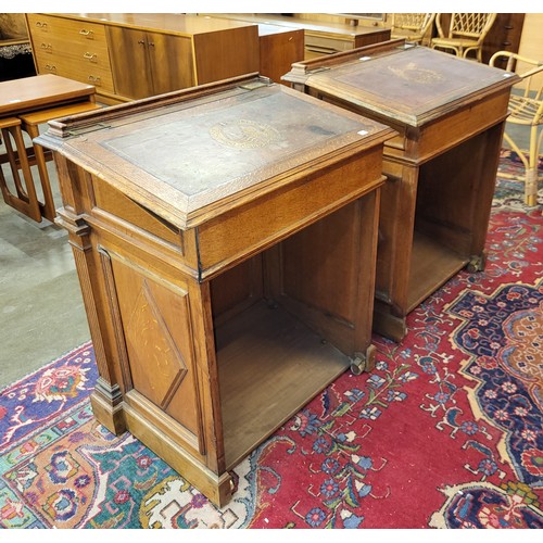 103 - A pair of Victorian Gothic Revival oak clerks desks, the gilt tooled red leather tops inset with Lat... 